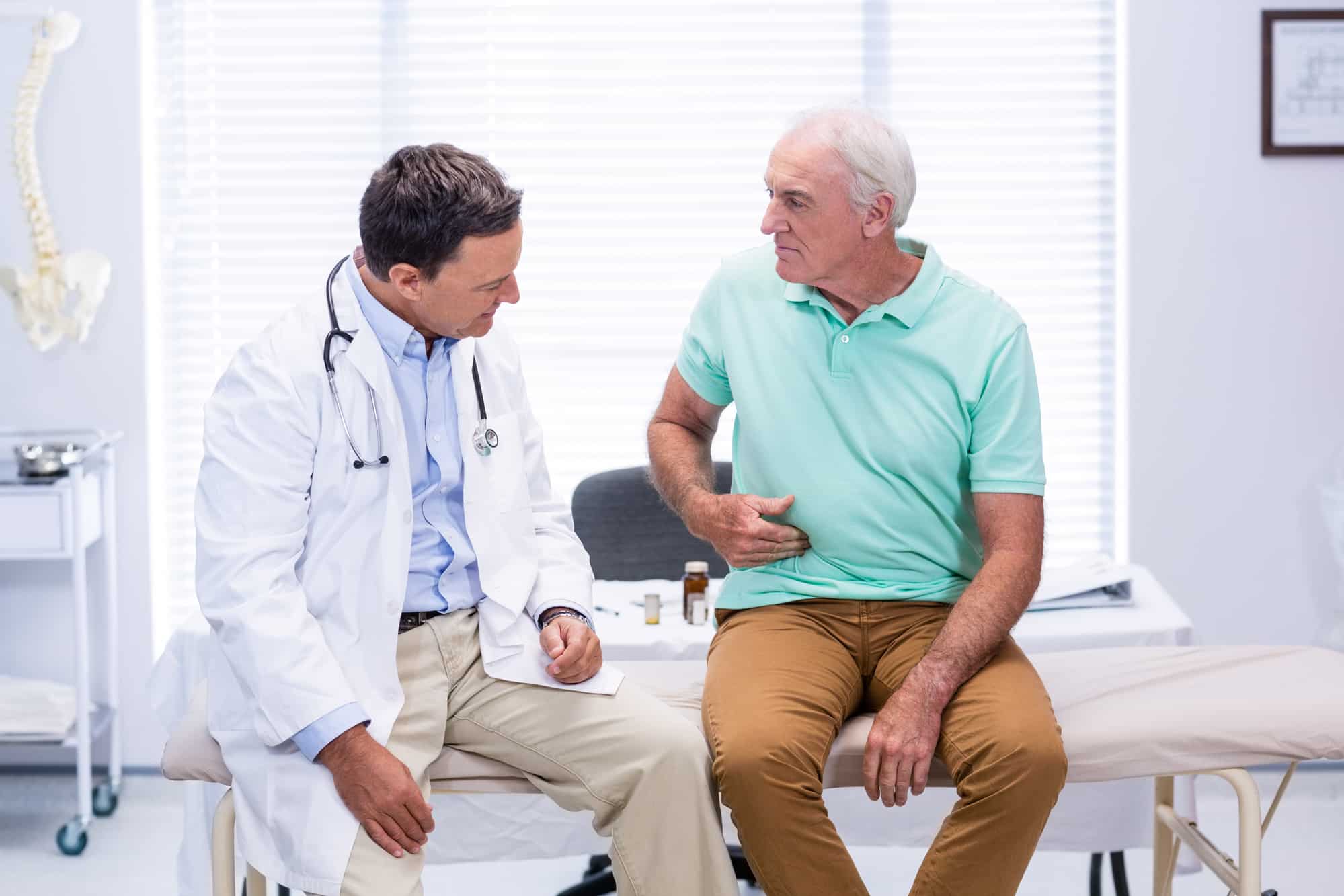 doctor and patient discussing abdominal pain